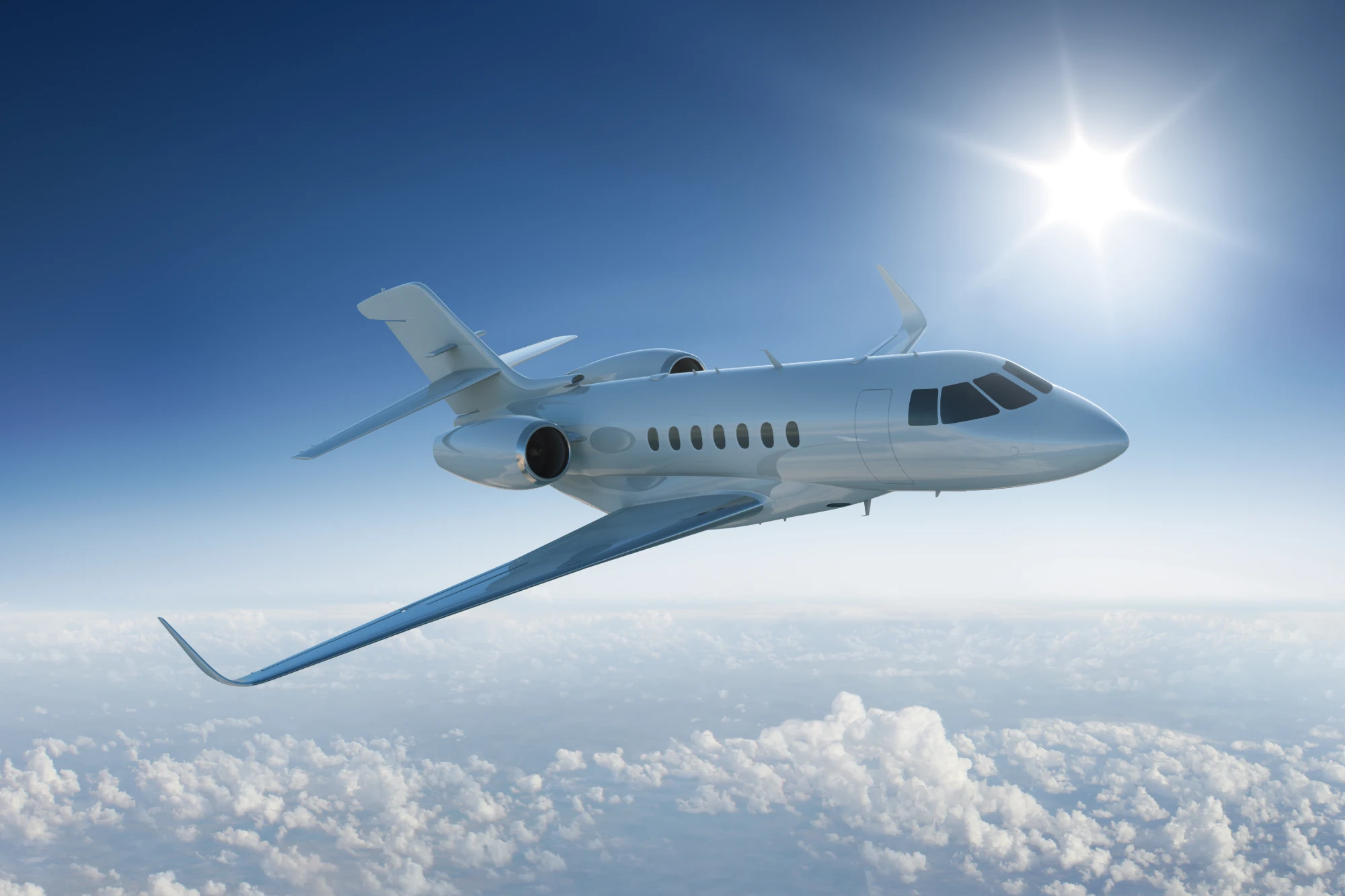 Private jet flying above the clouds.