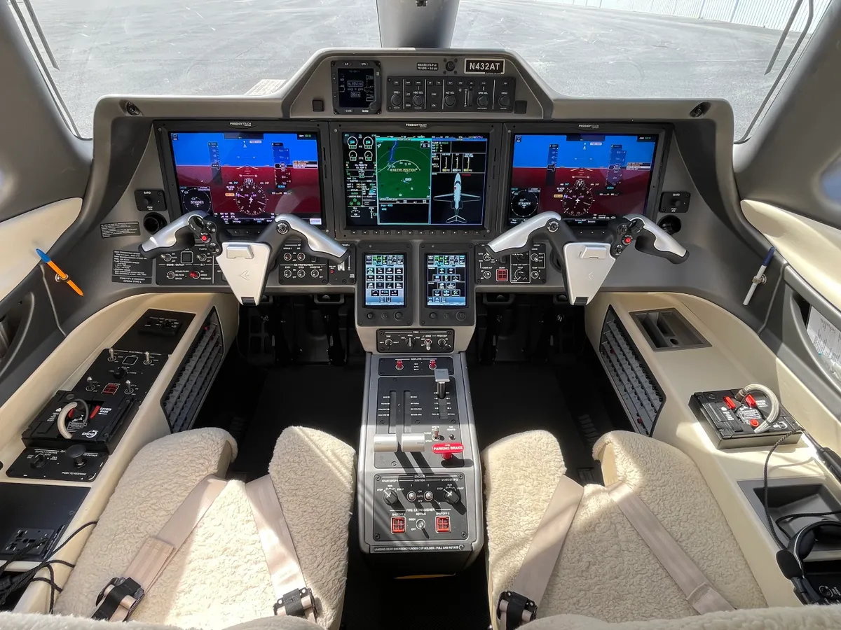 Aircraft cockpit with multiple control screens.